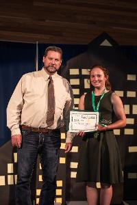 girl getting award from adult